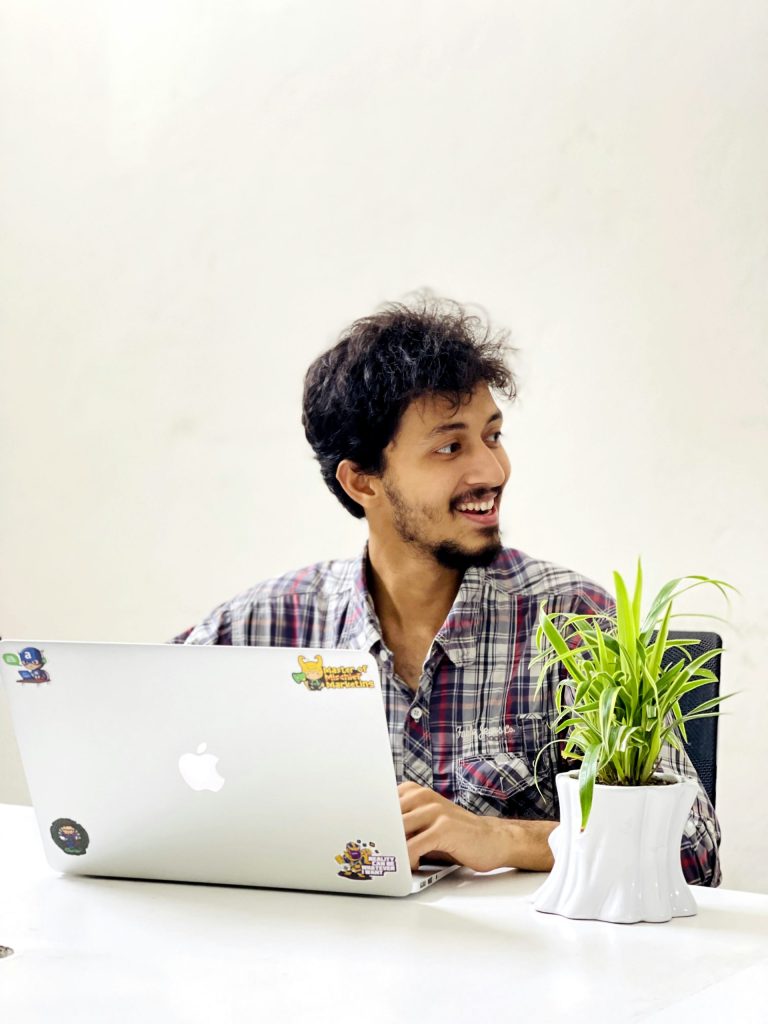 A man sitting in front of a laptop computer